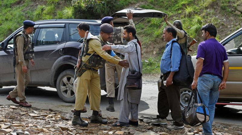 Security personnel frisking the yatris and the locals before they head towards the holy cave shrine following the militant attack on a bus in which seven pilgrims were killed and 19 others injured, at Nuwun base Camp in South Kashmir on Tuesday. (Photo: PTI) Security personnel frisking the yatris and the locals before they head towards the holy cave shrine following the militant attack on a bus in which seven pilgrims were killed and 19 others injured, at Nuwun base Camp in South Kashmir on Tuesday. (Photo: PTI)