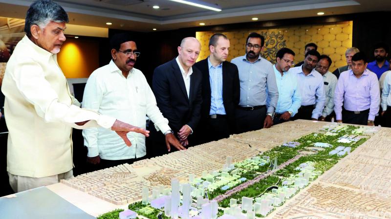Chief Minister N. Chandrababu Naidu and Minister for Municipal Administration P. Narayana check Amaravati core capital city design at AP Secretariat, Velagapdui village on Friday. (Photo: DC) Chief Minister N. Chandrababu Naidu and Minister for Municipal Administration P. Narayana check Amaravati core capital city design at AP Secretariat, Velagapdui village on Friday. (Photo: DC)