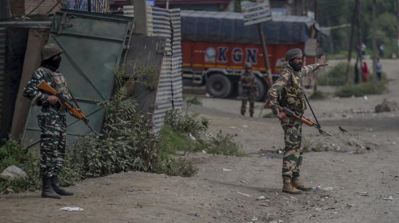 Indian army soldiers stand guard at the site of shootout in Batengoo about 50 Kilometres (31.25 miles) south Srinagar, Indian controlled Kashmir. (Photo: AP) Indian army soldiers stand guard at the site of shootout in Batengoo about 50 Kilometres (31.25 miles) south Srinagar, Indian controlled Kashmir. (Photo: AP)