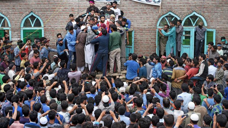 Villagers prepare for funeral prayers of one of the three militants who were killed during an encounter with security forces at Bahmoo village of Keller, 60 kms from Srinagar. (Photo: PTI) Villagers prepare for funeral prayers of one of the three militants who were killed during an encounter with security forces at Bahmoo village of Keller, 60 kms from Srinagar. (Photo: PTI)