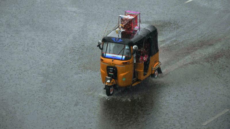 An auto-rickshaw plying at a road in rains in Hyderabad. (Photo: PTI) An auto-rickshaw plying at a road in rains in Hyderabad. (Photo: PTI)