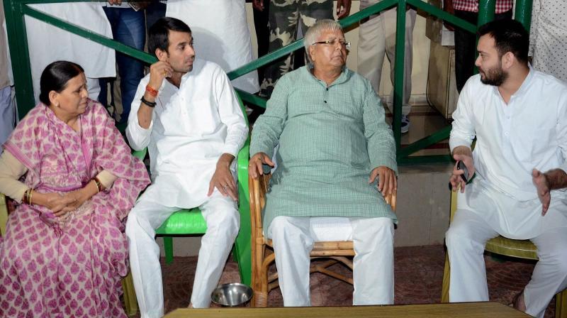 RJD Chief Lalu Prasad with wife Rabri Devi and sons Tej Pratap and Tejashwi Yadav at party lagislators meeting in Patna. (Photo: PTI) RJD Chief Lalu Prasad with wife Rabri Devi and sons Tej Pratap and Tejashwi Yadav at party lagislators meeting in Patna. (Photo: PTI)