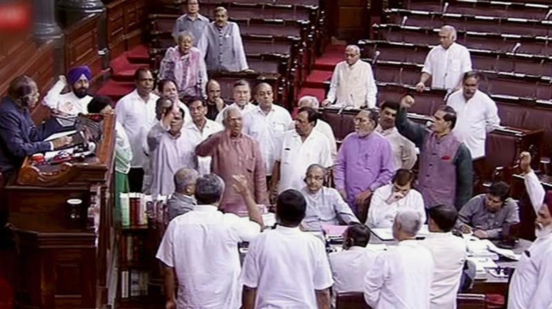Opposition members protesting in the Well of Rajya Sabha in the Parliament, New Delhi on Monday. (Photo: PTI) Opposition members protesting in the Well of Rajya Sabha in the Parliament, New Delhi on Monday. (Photo: PTI)