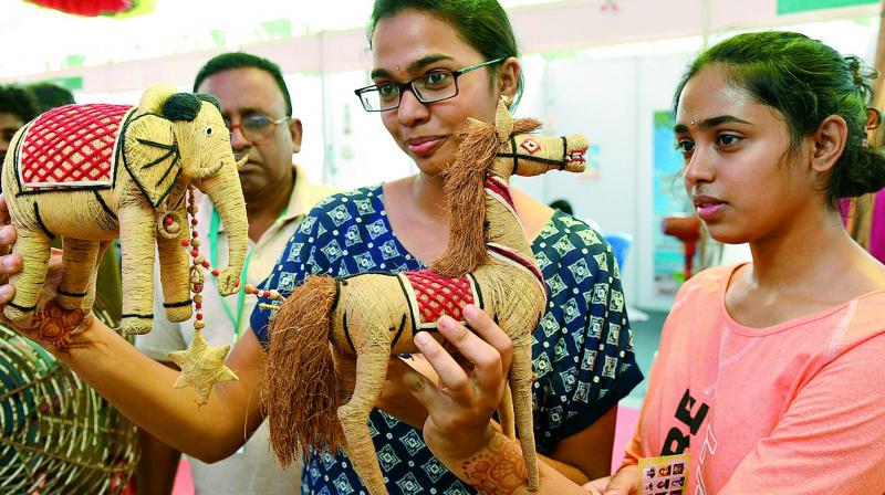 Girls take a look the toys made from coconut fibre at a toys exhibition arranged on World Coconut Day in Vijayawada, on Saturday. (Photo: DC) Girls take a look the toys made from coconut fibre at a toys exhibition arranged on World Coconut Day in Vijayawada, on Saturday. (Photo: DC)