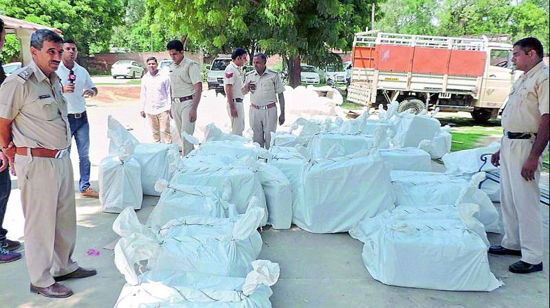 Police with recovered 84 cartons of firecrackers and explosive materials from the Dera premises on Saturday. (Photo: PTI) Police with recovered 84 cartons of firecrackers and explosive materials from the Dera premises on Saturday. (Photo: PTI)
