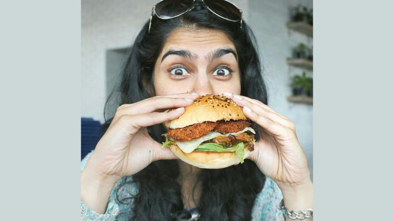 Carolyn, a city-based foodie poses with a healthy Quinoa burger. Carolyn, a city-based foodie poses with a healthy Quinoa burger.