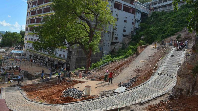 Kanakadurga temple officials construction road near Mallikharjuna Mahamandapam in Vijayawada on Tuesday.(Photo: DC) Kanakadurga temple officials construction road near Mallikharjuna Mahamandapam in Vijayawada on Tuesday.(Photo: DC)