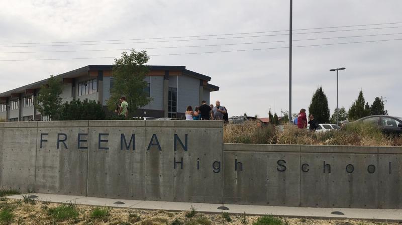 People gather outside of Freeman High School after reports of a shooting at the school in Rockford, Washington. (Photo: AP) People gather outside of Freeman High School after reports of a shooting at the school in Rockford, Washington. (Photo: AP)