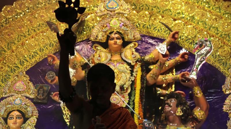 A Hindu priest worships before an idol of goddess Durga with oil lamp during Durga Puja festival in Kolkata, India. (Photo: AP) A Hindu priest worships before an idol of goddess Durga with oil lamp during Durga Puja festival in Kolkata, India. (Photo: AP)