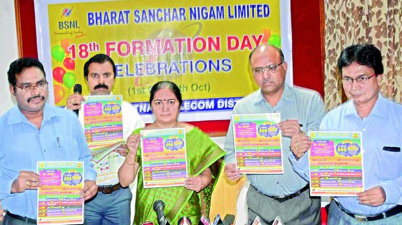 Principal General Manager of BSNL, Vizag Region, Nalini Varma along with her staff release a poster during a meeting at the BSNL office in Visakhapatnam on Tuesday. Principal General Manager of BSNL, Vizag Region, Nalini Varma along with her staff release a poster during a meeting at the BSNL office in Visakhapatnam on Tuesday.