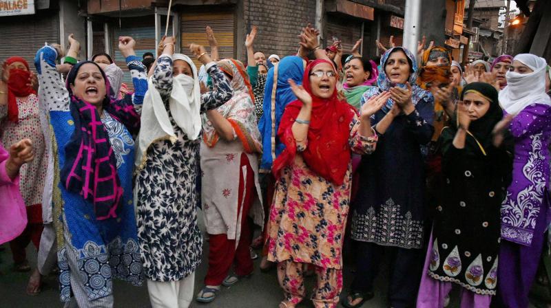 Women shout slogans and block a road during a protest against braid choping incidents in the Valley, at Habakadal in Srinagar. (Photo: PTI) Women shout slogans and block a road during a protest against braid choping incidents in the Valley, at Habakadal in Srinagar. (Photo: PTI)