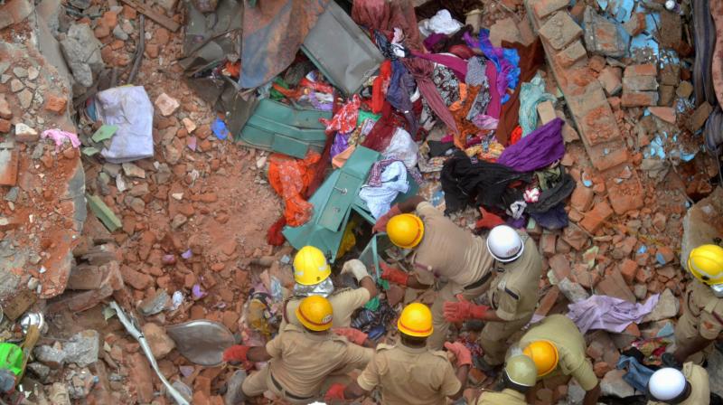 Fire personnel carrying out rescue work after a building collapsed due to a suspected cylinder blast at Ejipura area in Bengaluru on Monday. (Photo: PTI) Fire personnel carrying out rescue work after a building collapsed due to a suspected cylinder blast at Ejipura area in Bengaluru on Monday. (Photo: PTI)