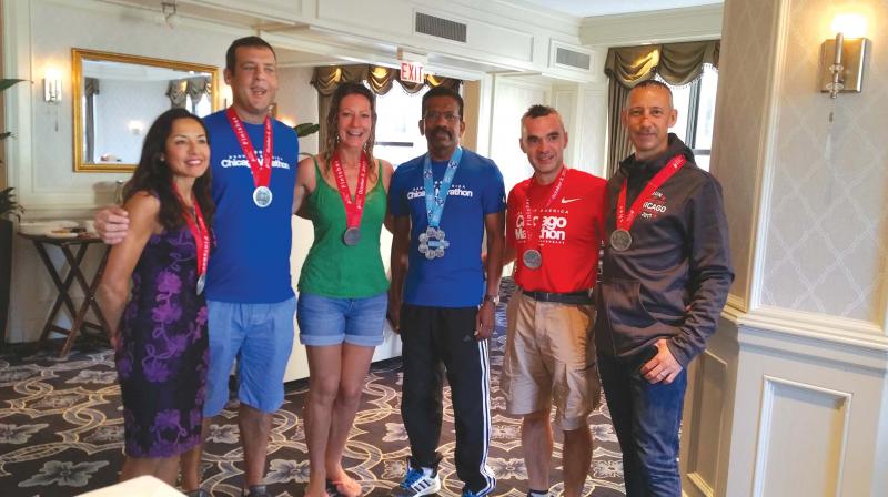 Ashok with fellow UK runners who received the Chicago medal. Ashok with fellow UK runners who received the Chicago medal.