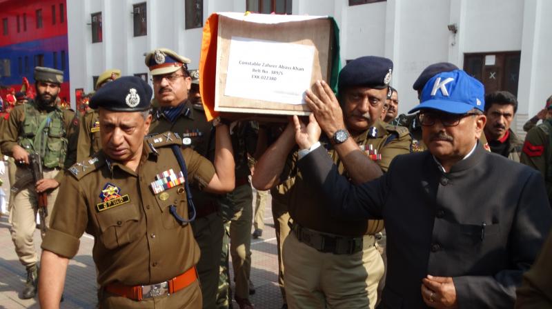 J&K's Deputy Chief Minister, Nirmal Singh, Director General of Police, Shesh Paul Vaid, and Inspector General of Police (Kashmir range) Munir Ahmed Khan join the pallbearers at a wreath-laying ceremony for fallen policeman Zaheer Abbas Khan in Srinagar on Sunday. J&K's Deputy Chief Minister, Nirmal Singh, Director General of Police, Shesh Paul Vaid, and Inspector General of Police (Kashmir range) Munir Ahmed Khan join the pallbearers at a wreath-laying ceremony for fallen policeman Zaheer Abbas Khan in Srinagar on Sunday.