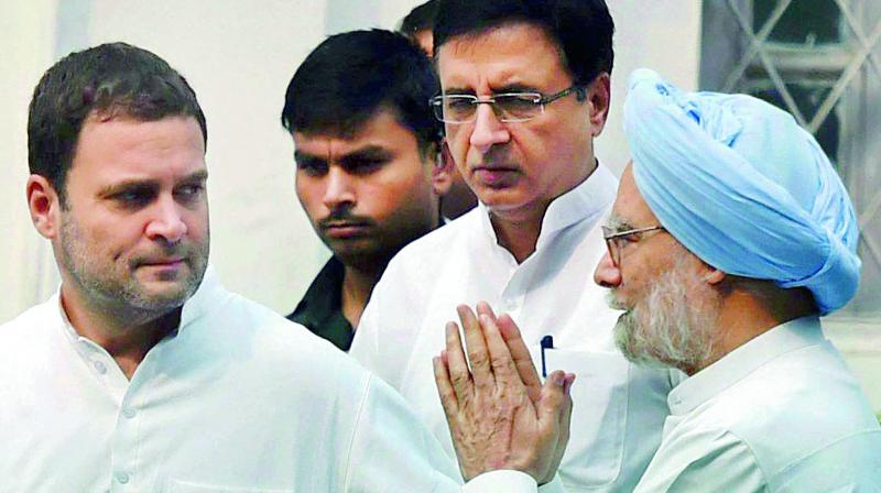 Congress vice-president Rahul Gandhi with former Prime Minister Manmohan Singh and Randeep Surjewala in New Delhi on Monday. (Photo: PTI) Congress vice-president Rahul Gandhi with former Prime Minister Manmohan Singh and Randeep Surjewala in New Delhi on Monday. (Photo: PTI)