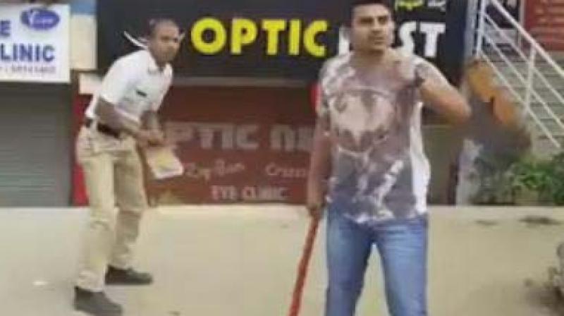 A video grab of Dileep beating up traffic police constable Bheemashankar with a baseball bat. A video grab of Dileep beating up traffic police constable Bheemashankar with a baseball bat.