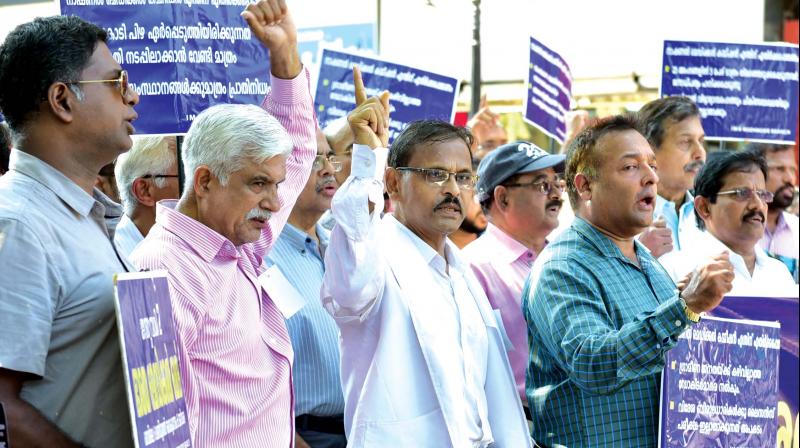 Doctors protesting against NMC bill in Kozhikode on Tuesday. (DC File) Doctors protesting against NMC bill in Kozhikode on Tuesday. (DC File)