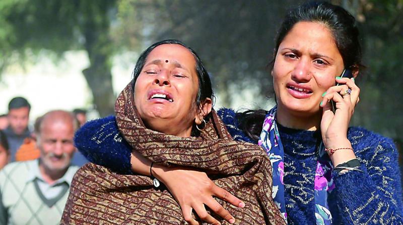 Wailing relatives of Ghar Singh, who was killed after Pakistan opened heavy fire and shot mortars along the India Pakistan border, grieve in R.S. Pura Sector on Saturday. (Photo: PTI) Wailing relatives of Ghar Singh, who was killed after Pakistan opened heavy fire and shot mortars along the India Pakistan border, grieve in R.S. Pura Sector on Saturday. (Photo: PTI)