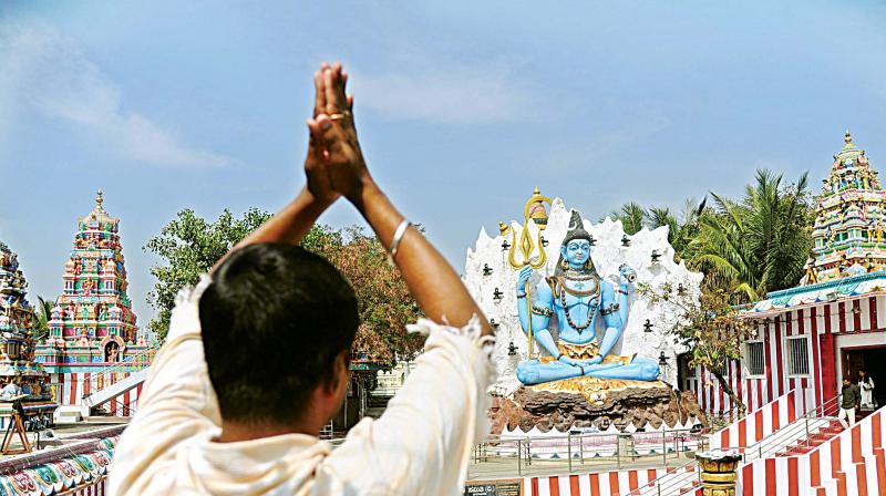A devotee prays at the painted and decorated Shiva temple at Kurubarahalli ahead of the Shivaratri festival in Bengaluru on Monday. (Photo: DC) A devotee prays at the painted and decorated Shiva temple at Kurubarahalli ahead of the Shivaratri festival in Bengaluru on Monday. (Photo: DC)