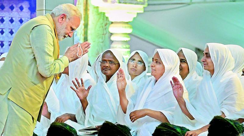 Prime Minister Narendra Modi greets saints at Bahubali Mahamasthakabhisheka Mahotsava at Shravanabelagola in Hassan on Monday. (Photo: PTI) Prime Minister Narendra Modi greets saints at Bahubali Mahamasthakabhisheka Mahotsava at Shravanabelagola in Hassan on Monday. (Photo: PTI)