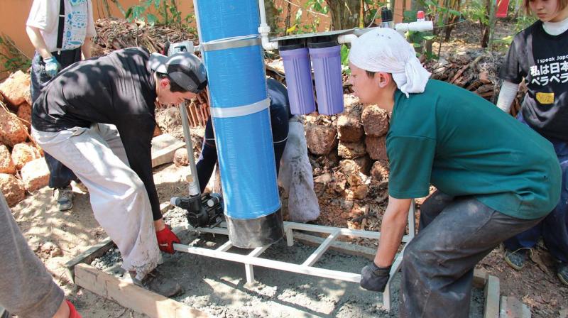 Students installing water filtration system. Students installing water filtration system.
