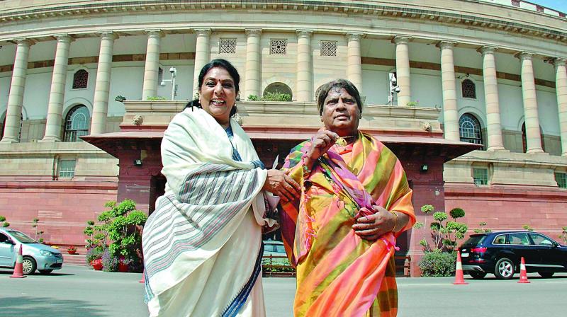 Congress MP Renuka Chowdhury shares a light moment with TD MP Shiva Prasad as he stages a protest in a sari against the NDA government demanding special category status for Andhra Pradesh, outside Parliament in New Delhi on Monday. Congress MP Renuka Chowdhury shares a light moment with TD MP Shiva Prasad as he stages a protest in a sari against the NDA government demanding special category status for Andhra Pradesh, outside Parliament in New Delhi on Monday.