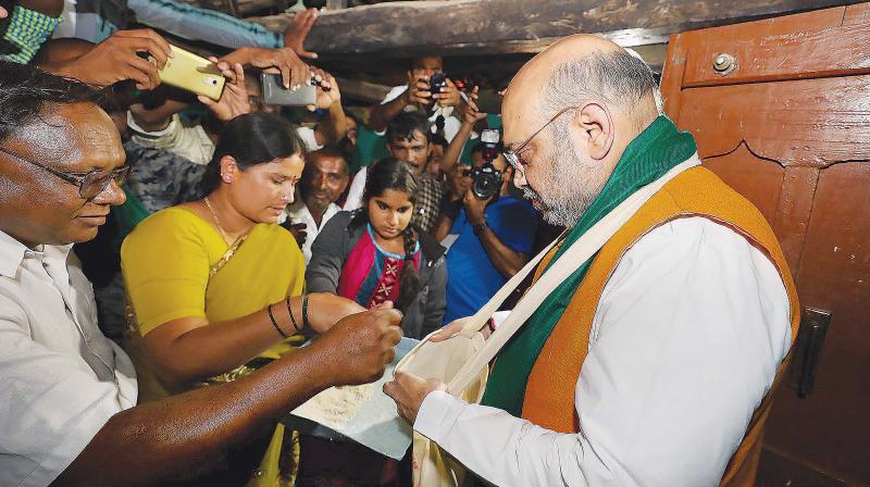BJP president Amit Shah meets voters at Chinnenahalli village near Srirangapatna on Saturday. (Photo: PTI) BJP president Amit Shah meets voters at Chinnenahalli village near Srirangapatna on Saturday. (Photo: PTI)