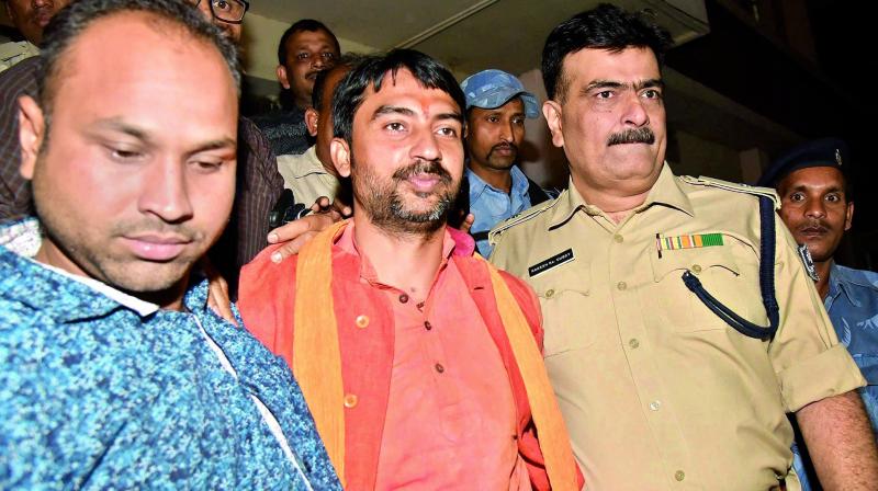 RSS leader Arijit Shashwat being taken away by police after his arrest, in Patna on Sunday. (Photo: PTI) RSS leader Arijit Shashwat being taken away by police after his arrest, in Patna on Sunday. (Photo: PTI)