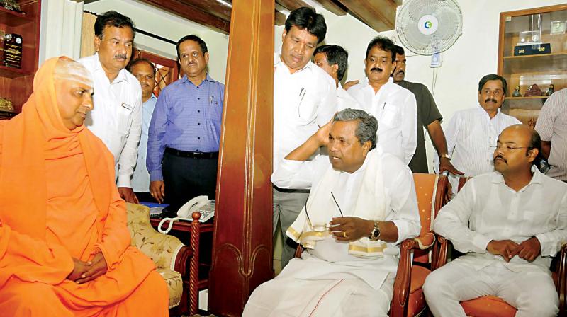Chief Minister Siddaramaiah with Sri Shivaratrideshikendra Swami at Suttur Math in Mysuru on Friday. (Photo: KPN) Chief Minister Siddaramaiah with Sri Shivaratrideshikendra Swami at Suttur Math in Mysuru on Friday. (Photo: KPN)