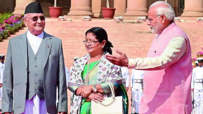 Prime Minister Narendra Modi with his Nepalese counterpart Khadga Prasad Oli as his wife Radhika Shakya looks on during the ceremonial reception at the forecourt of Rashtrapati Bhavan in New Delhi on Saturday. (Photo: PTI) Prime Minister Narendra Modi with his Nepalese counterpart Khadga Prasad Oli as his wife Radhika Shakya looks on during the ceremonial reception at the forecourt of Rashtrapati Bhavan in New Delhi on Saturday. (Photo: PTI)