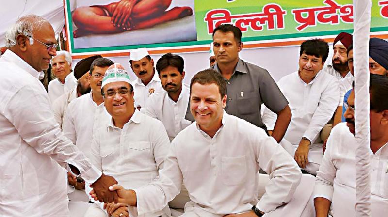 Congress president Rahul Gandhi with party leaders Ajay Maken and Mallikarjun Kharge at a nationwide day-long fast against caste violence, at Rajghat in New Delhi. (Photo: PTI) Congress president Rahul Gandhi with party leaders Ajay Maken and Mallikarjun Kharge at a nationwide day-long fast against caste violence, at Rajghat in New Delhi. (Photo: PTI)