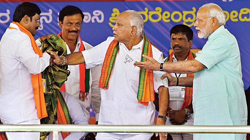 PM Narendra Modi pacifies state BJP president B.S. Yeddyurappa after an altercation on stage at the election rally at Santhemarahalli near Chamarajanagar on Tuesday. (Photo:AP) PM Narendra Modi pacifies state BJP president B.S. Yeddyurappa after an altercation on stage at the election rally at Santhemarahalli near Chamarajanagar on Tuesday. (Photo:AP)