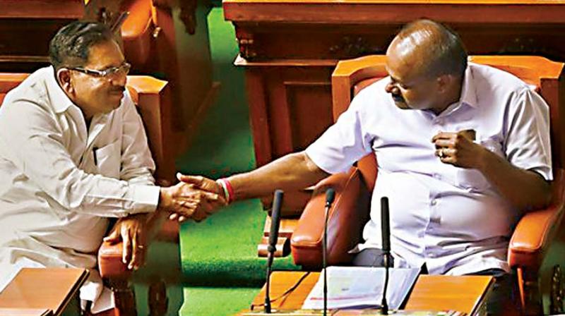 CM H.D. Kumaraswamy and Dy CM G. Parameshwar greet each other after their coalition government won the trust vote. (Photo: PTI) CM H.D. Kumaraswamy and Dy CM G. Parameshwar greet each other after their coalition government won the trust vote. (Photo: PTI)