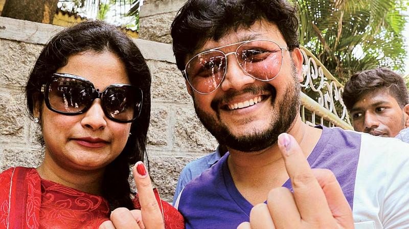 Actor Ganesh with his wife Shilpa after casting their vote in RR Nagar on Monday. (Photo: DC) Actor Ganesh with his wife Shilpa after casting their vote in RR Nagar on Monday. (Photo: DC)