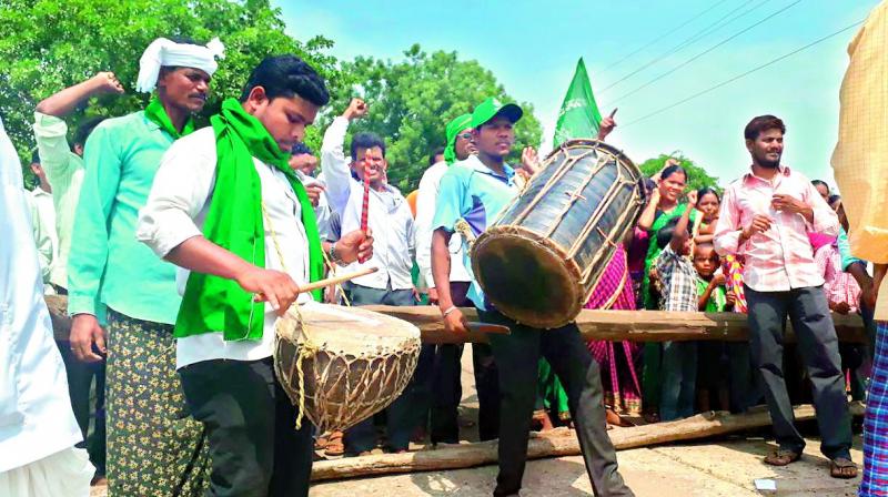 Members of the tribal community beat traditional drums to declare ‘self-rule’ under the special provisions of the Constitution at Kothaguda in Utnoor mandal in old Adilabad district on Friday. (Photo: DC) Members of the tribal community beat traditional drums to declare ‘self-rule’ under the special provisions of the Constitution at Kothaguda in Utnoor mandal in old Adilabad district on Friday. (Photo: DC)