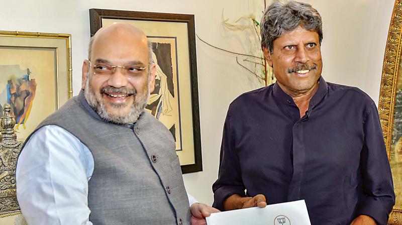 BJP chief Amit Shah meets former cricketer Kapil Dev during his ‘Sampark for Samarthan’ campaign to generate awareness about the NDA government’s achievements, in New Delhi on Friday. (Photo: PTI) BJP chief Amit Shah meets former cricketer Kapil Dev during his ‘Sampark for Samarthan’ campaign to generate awareness about the NDA government’s achievements, in New Delhi on Friday. (Photo: PTI)