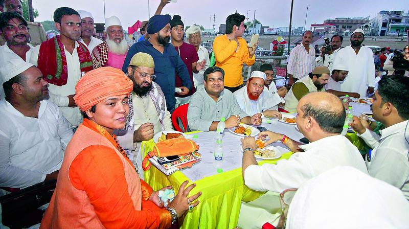 Muslims at an iftar party, organised by Mankameshwar Temple Mahant Diviya Giri, in Lucknow on Sunday. (Photo: PTI) Muslims at an iftar party, organised by Mankameshwar Temple Mahant Diviya Giri, in Lucknow on Sunday. (Photo: PTI)