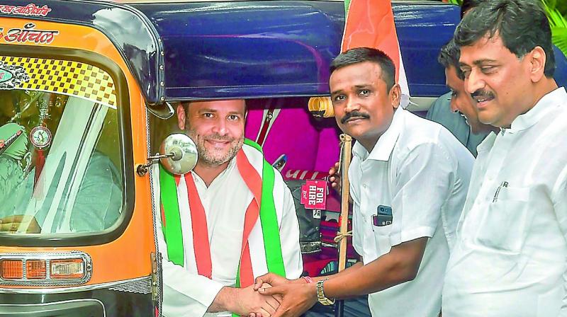 Congress President Rahul Gandhi shakes hands with an auto-rickshaw driver before a meeting, in Mumbai on Tuesday. (Photo: PTI) Congress President Rahul Gandhi shakes hands with an auto-rickshaw driver before a meeting, in Mumbai on Tuesday. (Photo: PTI)