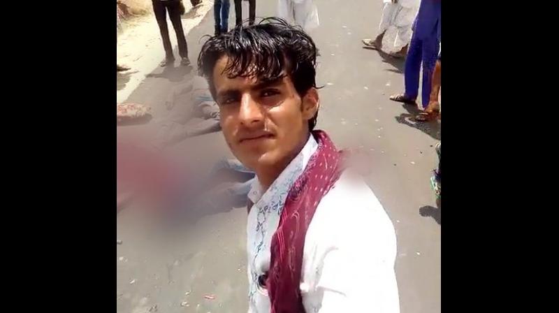 A picture of the incident showing an unidentified man clicking a selfie with one of the injured as his background. (Photo: ANI/Twitter) A picture of the incident showing an unidentified man clicking a selfie with one of the injured as his background. (Photo: ANI/Twitter)