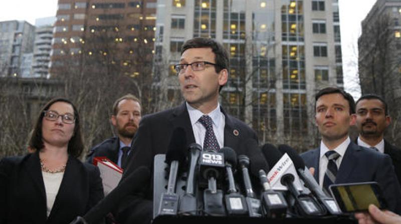 Washington Attorney General Bob Ferguson, center, talks to reporters as Solicitor General Noah Purcell, second from right, looks on, following a hearing in federal court in Seattle. (Photo: AP) Washington Attorney General Bob Ferguson, center, talks to reporters as Solicitor General Noah Purcell, second from right, looks on, following a hearing in federal court in Seattle. (Photo: AP)