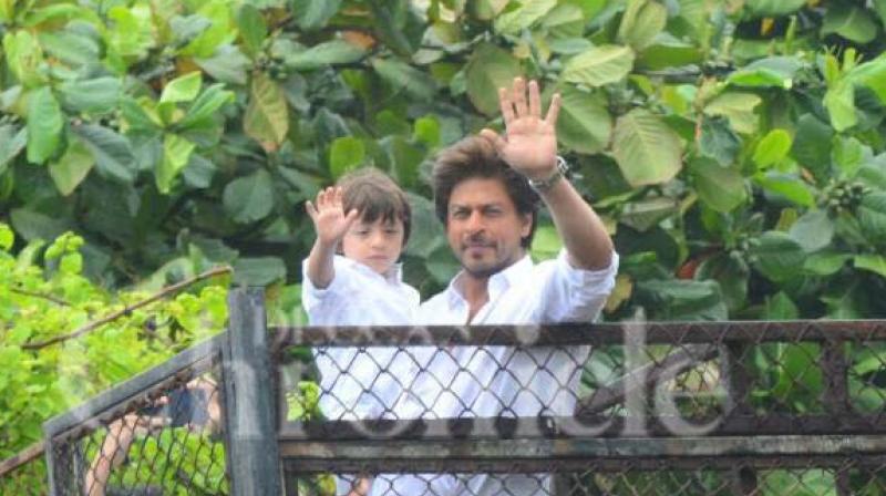 Shah Rukh Khan, with his son AbRam greets his fans gathered outside Mannat on the occasion of Eid. (Photo: Viral Bhayani) Shah Rukh Khan, with his son AbRam greets his fans gathered outside Mannat on the occasion of Eid. (Photo: Viral Bhayani)