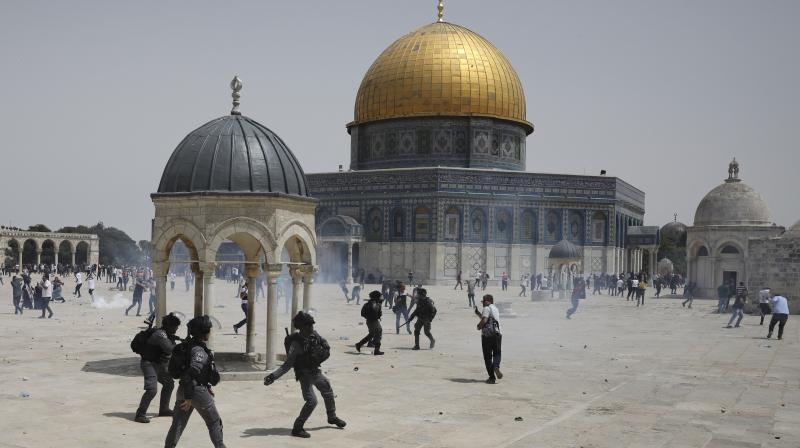 Palestinians run from sound grenades thrown by Israeli police in front of the Dome of the Rock in the al-Aqsa mosque complex in Jerusalem, Friday, May 21, 202, as a cease-fire took effect between Hamas and Israel after a 11-day war. (AP/Mahmoud Illean) Palestinians run from sound grenades thrown by Israeli police in front of the Dome of the Rock in the al-Aqsa mosque complex in Jerusalem, Friday, May 21, 202, as a cease-fire took effect between Hamas and Israel after a 11-day war. (AP/Mahmoud Illean)