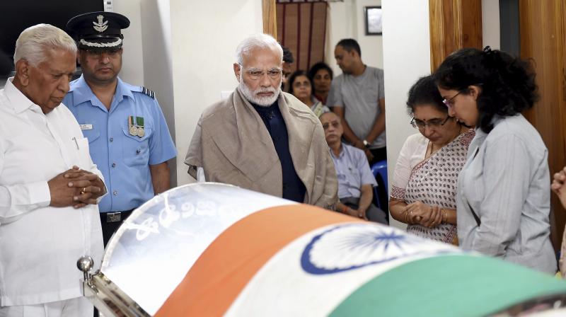 Prime Minister Narendra Modi visited Ananth Kumar's residence at Basavanagudi and paid homage to his colleague by placing a wreath on his mortal remains on Monday night. (Photo: PTI) Prime Minister Narendra Modi visited Ananth Kumar's residence at Basavanagudi and paid homage to his colleague by placing a wreath on his mortal remains on Monday night. (Photo: PTI)