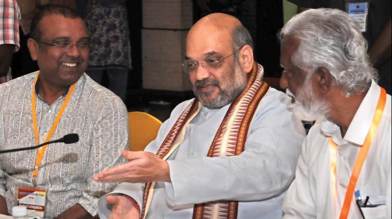 BDJS state president Thushar Vellapally, BJP national president Amit Shah and party’s state president Kummanam Rajasekharan during the NDA meeting in Kochi on Friday. (Photo: ARUN CHANDRABOSE) BDJS state president Thushar Vellapally, BJP national president Amit Shah and party’s state president Kummanam Rajasekharan during the NDA meeting in Kochi on Friday. (Photo: ARUN CHANDRABOSE)