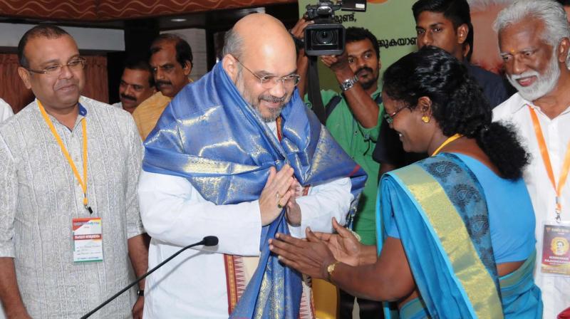 BJP president Amit Shah greets Janadhipathya Rashtriya Sabha leader K. Janu at the NDA meeting in Kochi on Friday. BJP state president Kummanam Rajasekharan, BDJS leader Thushar Vellapally and Kerala Congress leader P.C.Thomas look on. (Photo: ARUNCHANDRA BOSE) BJP president Amit Shah greets Janadhipathya Rashtriya Sabha leader K. Janu at the NDA meeting in Kochi on Friday. BJP state president Kummanam Rajasekharan, BDJS leader Thushar Vellapally and Kerala Congress leader P.C.Thomas look on. (Photo: ARUNCHANDRA BOSE)