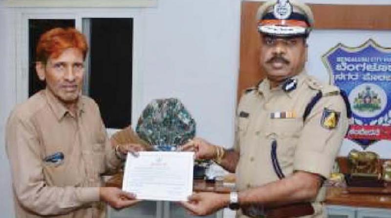 Syed Ahmed receives his award from Police Commissioner T. Suneel Kumar. Syed Ahmed receives his award from Police Commissioner T. Suneel Kumar.