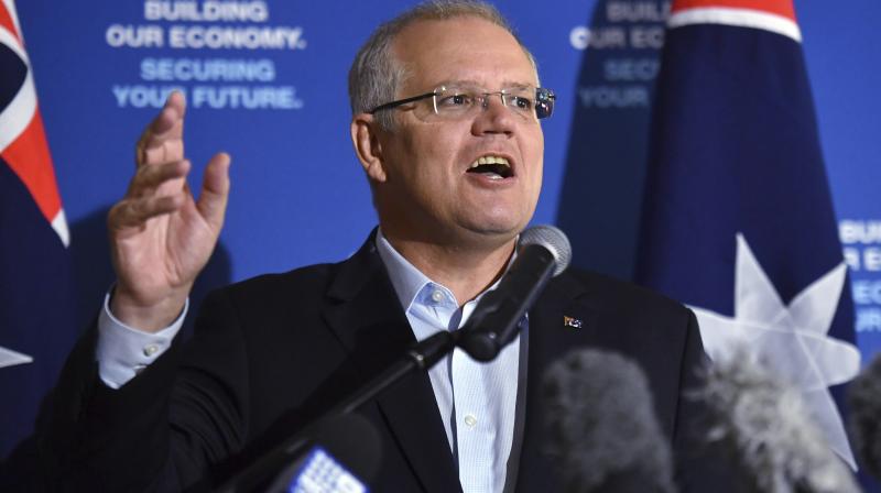 The woman was wrestled away by Morrison's close protection security detail and could later be seen leaving the venue holding an egg carton. (Photo:AP) The woman was wrestled away by Morrison's close protection security detail and could later be seen leaving the venue holding an egg carton. (Photo:AP)