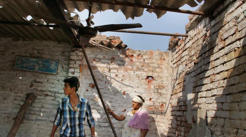 illagers show a damaged roof house due to alleged shelling from across the LoC at the India-Pakistan International border in Bidipur village of RS Pura sector, Jammu. (Photo: PTI) illagers show a damaged roof house due to alleged shelling from across the LoC at the India-Pakistan International border in Bidipur village of RS Pura sector, Jammu. (Photo: PTI)