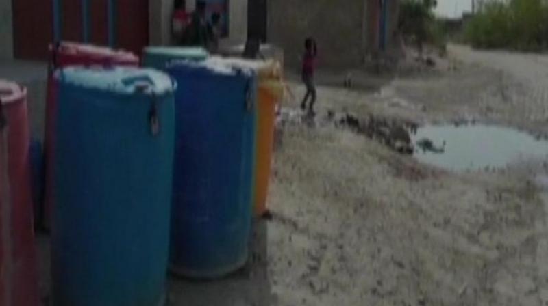 'Due to acute shortage of water, there have been cases of water theft at night a couple of times. So, we have decided to put locks in our drums to save our share of water,' a local said. (Photo: ANI) 'Due to acute shortage of water, there have been cases of water theft at night a couple of times. So, we have decided to put locks in our drums to save our share of water,' a local said. (Photo: ANI)