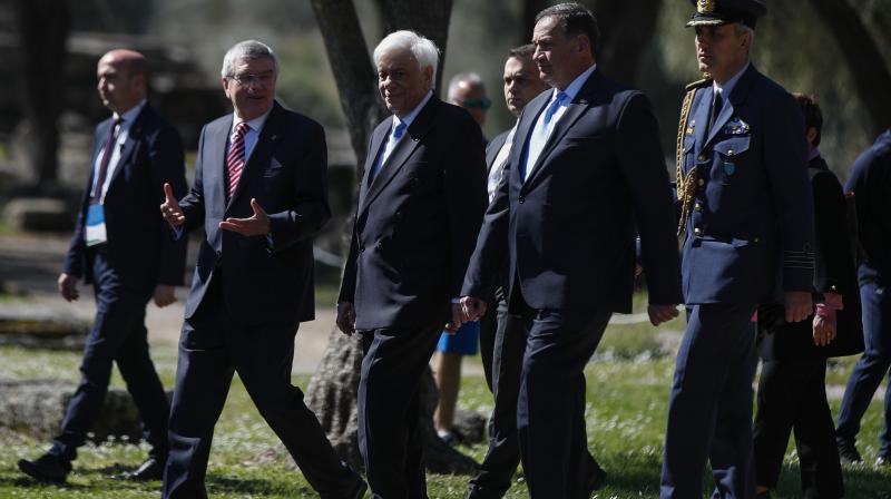 IOC President Thomas Bach (2nd left) arrives for the flame lighting ceremony at the closed Ancient Olympia site, birthplace of the ancient Olympics in southern Greece, along with Head of the Hellenic Olympic committee Spyros Kapralos and Greek President Prokopis Pavlopoulos last Wednesday. AP Photo IOC President Thomas Bach (2nd left) arrives for the flame lighting ceremony at the closed Ancient Olympia site, birthplace of the ancient Olympics in southern Greece, along with Head of the Hellenic Olympic committee Spyros Kapralos and Greek President Prokopis Pavlopoulos last Wednesday. AP Photo
